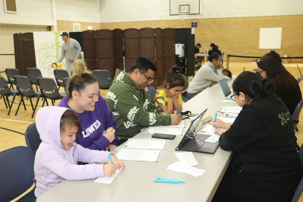 A family signing up to get their immunisations at our weekend event last year, manukau 2023