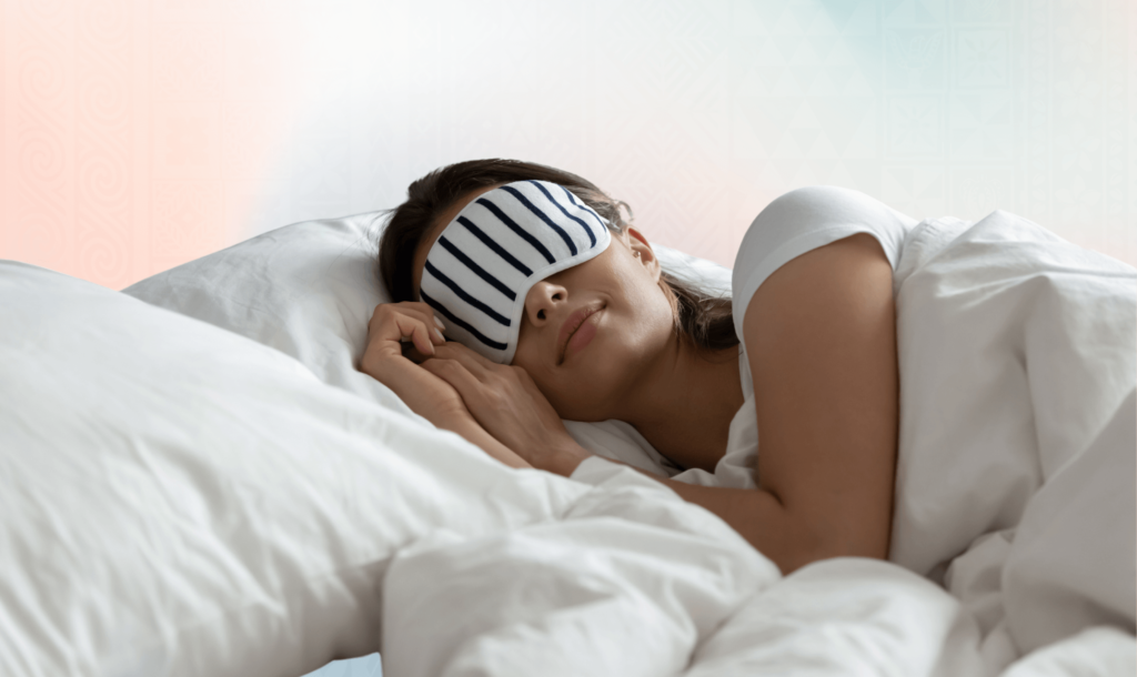 A lady having a relaxing sleep in bed with a sleeping eye mask